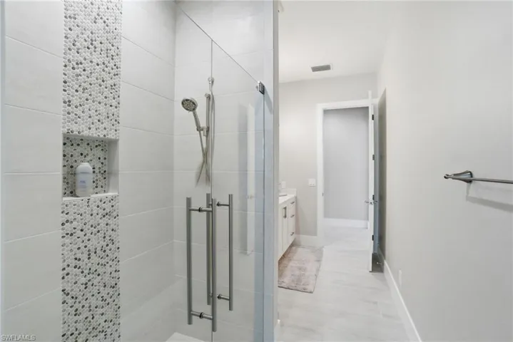 Bathroom featuring vanity and shower