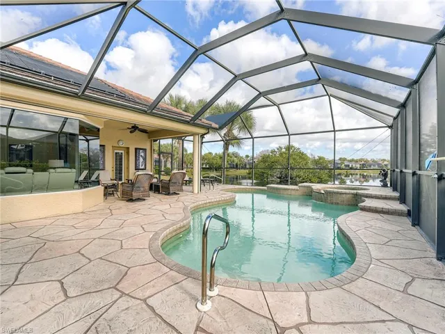 Large pool deck with view of "bird island" in the only natural lake in the community