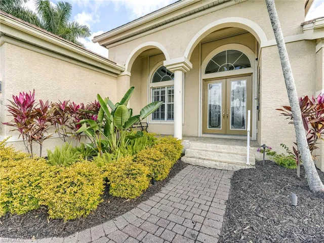 Classic Florida front porch with French door entry.  All openings protected with roll-down shutters.