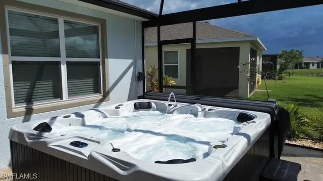 Unfurnished bedroom featuring light carpet, ceiling fan, and ensuite bathroom