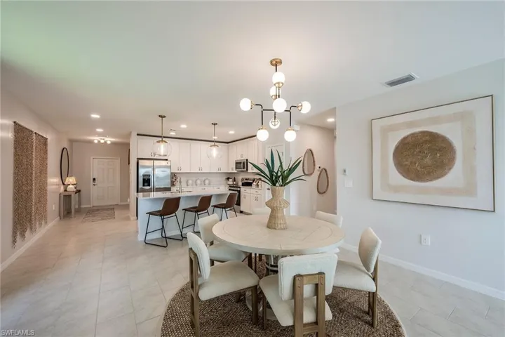 Dining space with a chandelier, recessed lighting, and light tile patterned floors