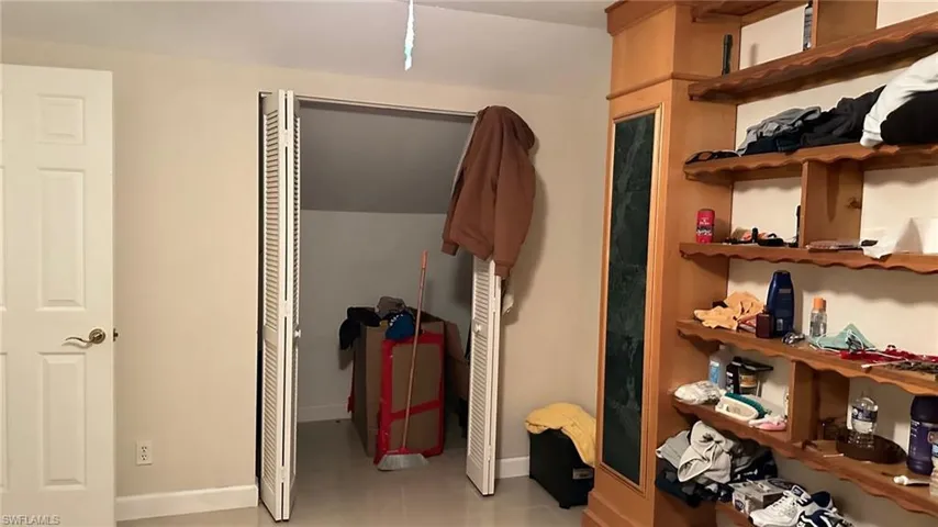 Bedroom featuring light tile patterned floors and a closet