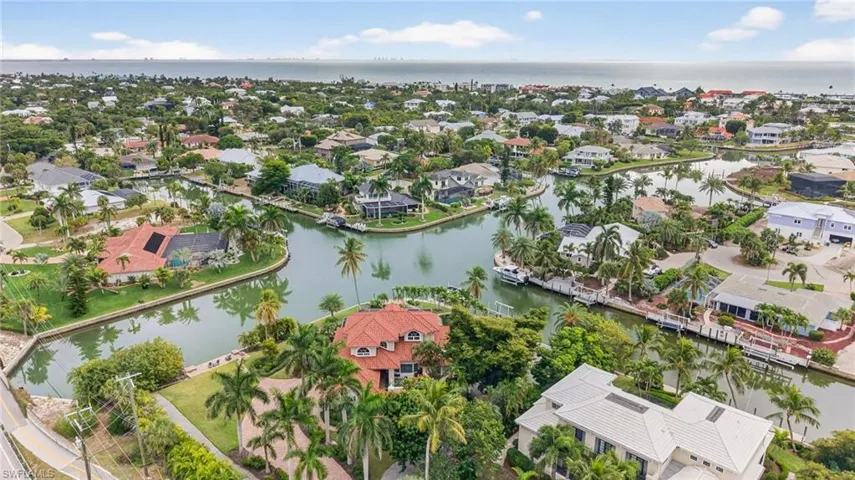 Aerial view of residential area featuring a large body of water