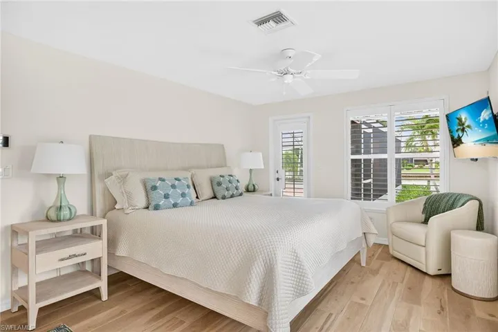 Primary Bedroom featuring light wood-style flooring, a ceiling fan, and access to outside