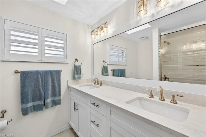 Bathroom with double vanity and a shower stall