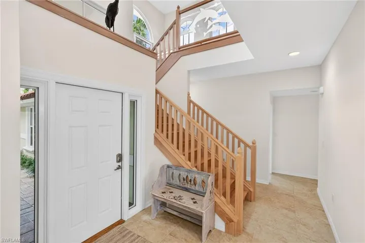 Foyer featuring stairway, recessed lighting, and light tile patterned flooring