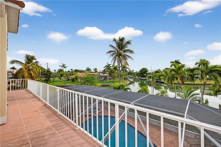 Balcony featuring view of pool and a water view