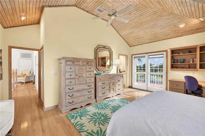 Bedroom featuring wooden ceiling, access to outside, ceiling fan, high vaulted ceiling, and light wood-style floors