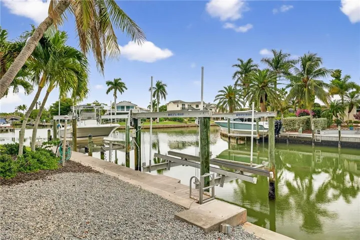Dock featuring boat lift and a water view