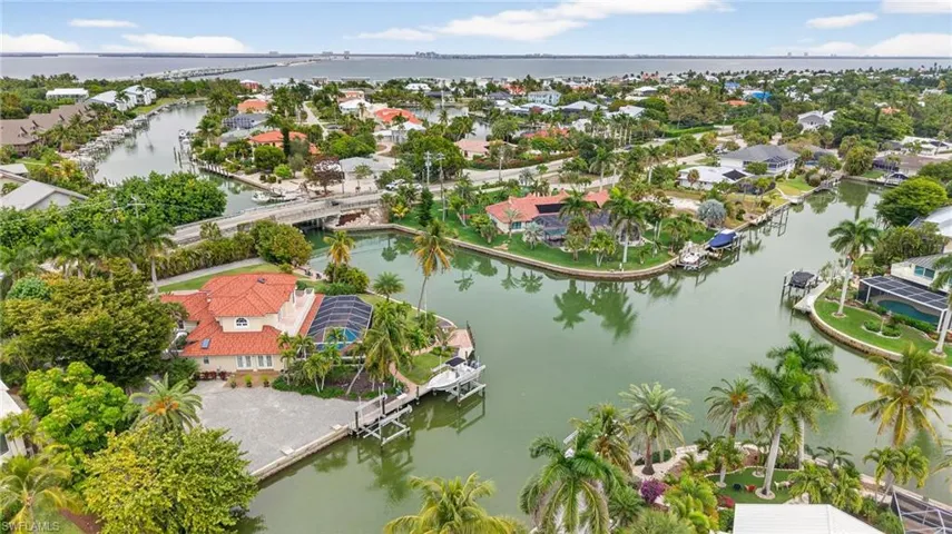 Aerial view of residential area featuring a nearby body of water