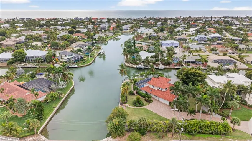 Aerial perspective of suburban area with a nearby body of water