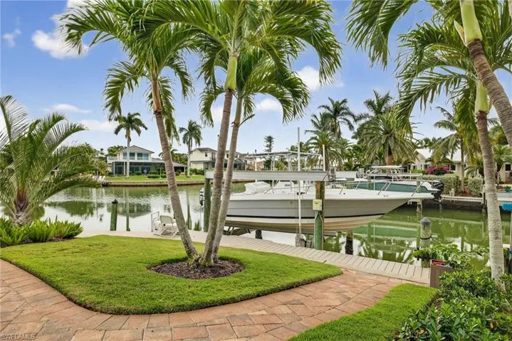 Dock featuring boat lift and a water view
