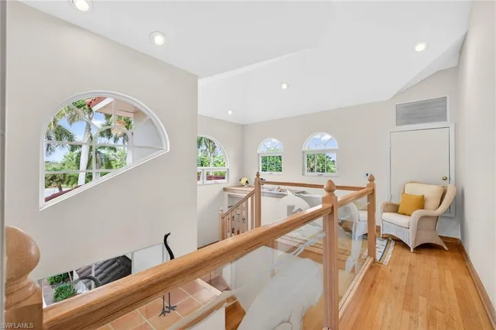 Hall featuring an upstairs landing, healthy amount of natural light, light wood finished floors, and recessed lighting