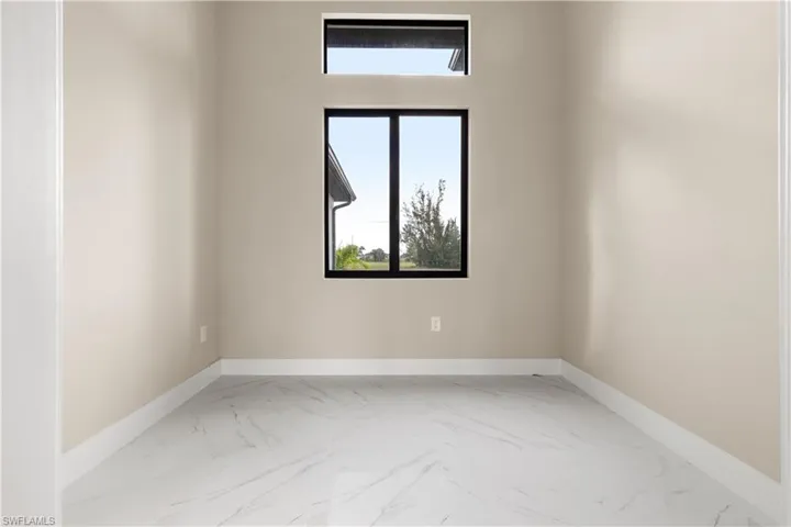 Unfurnished room featuring marble look tiles