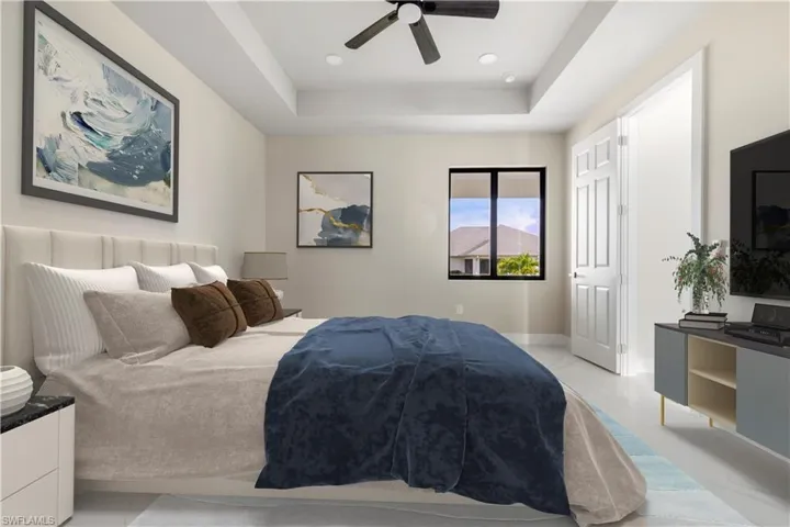 Bedroom featuring a raised ceiling, recessed lighting, and a ceiling fan