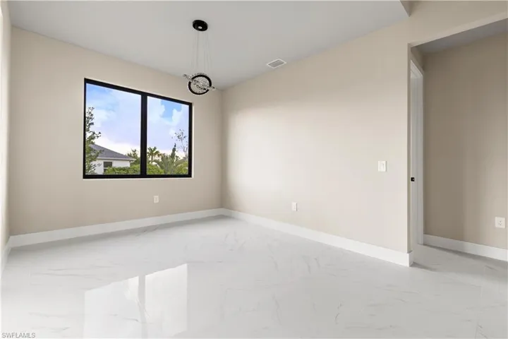 Empty room with light marble finish floors and baseboards
