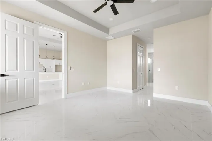 Unfurnished room featuring ceiling fan, light marble finish floors, and recessed lighting