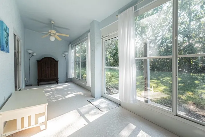 Unfurnished sunroom featuring plenty of natural light and ceiling fan