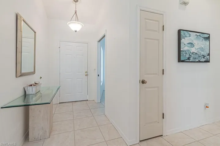 Corridor with light tile patterned flooring