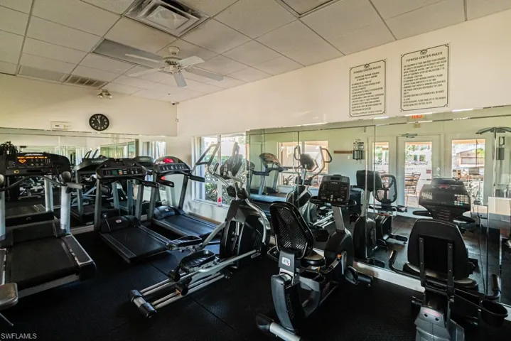 Workout area featuring a paneled ceiling and ceiling fan