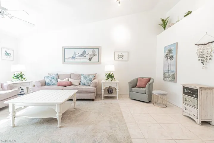 Living room featuring ceiling fan and light tile patterned floors