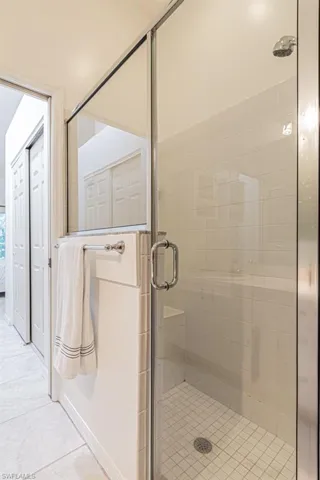 Master Bathroom featuring tile patterned floors and a shower with door
