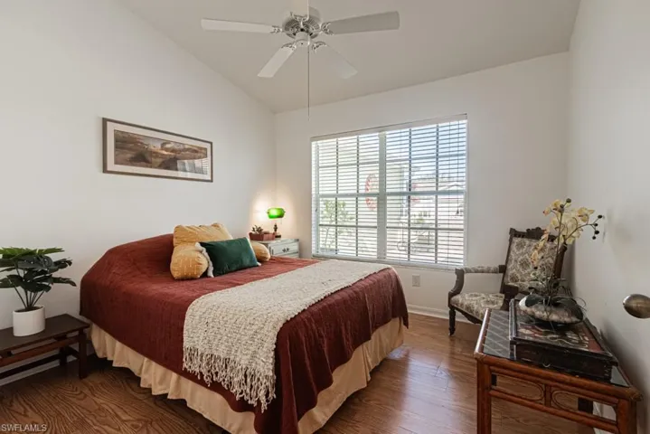 2nd Bedroom featuring ceiling fan, vaulted ceiling, dark hardwood / wood-style flooring, and multiple windows