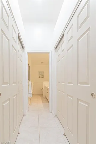 Hallway with light tile patterned floors