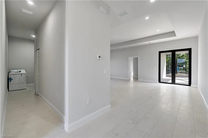 Hallway with washer / dryer and recessed lighting