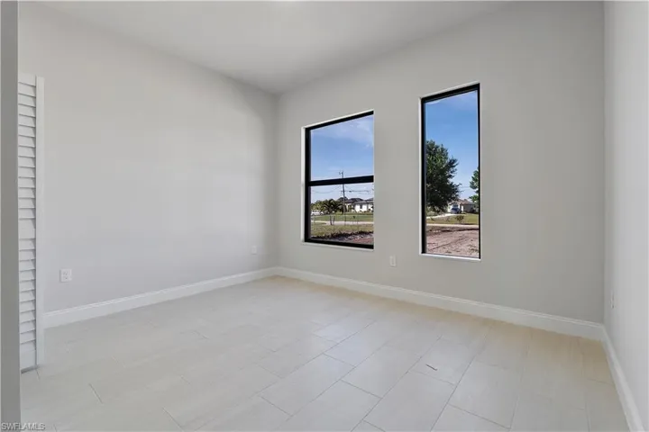 Unfurnished room with baseboards