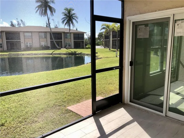 Screened patio with wood-finish tile flooring and sliding glass door access