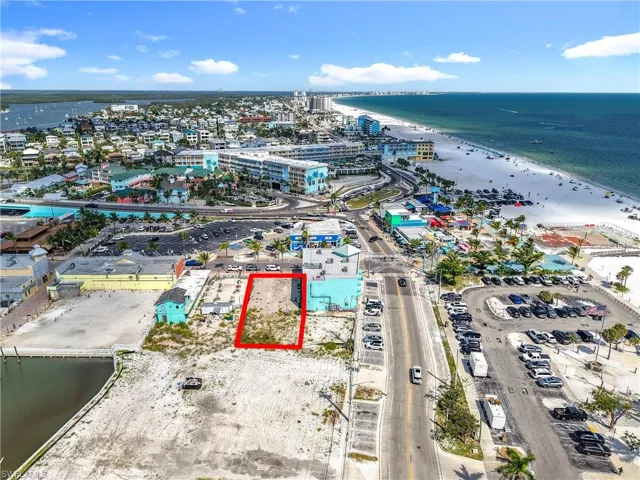 Aerial view of property and surrounding area with extended coastline and property boundaries highlighted