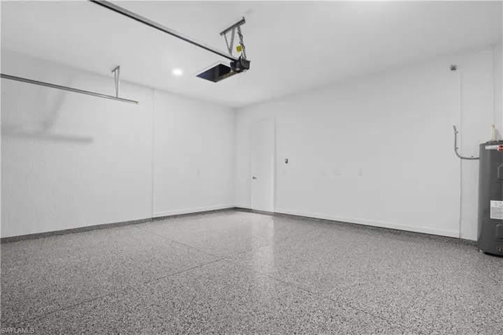 Garage with electric water heater and baseboards