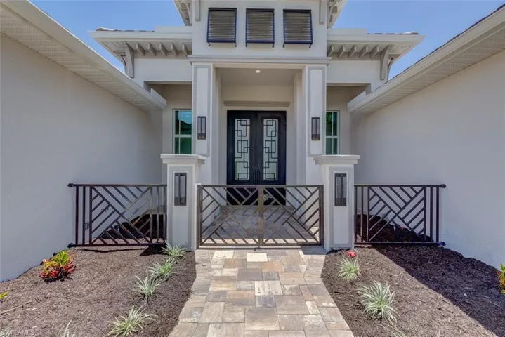 Doorway to property featuring stucco siding