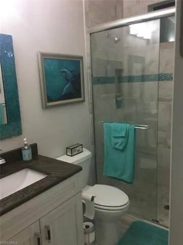 Full bath with vanity and a shower stall