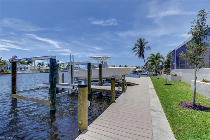 Dock area with boat lift and a water view