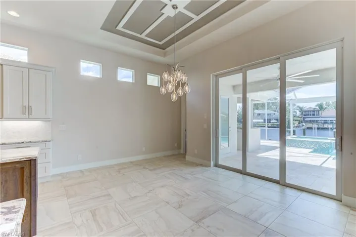 Unfurnished dining area featuring a ceiling fan and baseboards