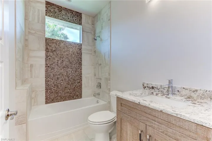 Bathroom with vanity and shower / bathtub combination