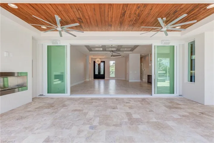 Unfurnished room featuring wooden ceiling, a ceiling fan, and a raised ceiling