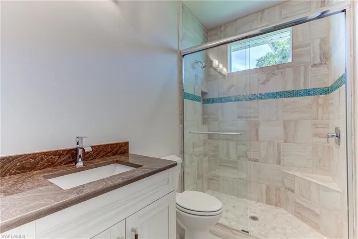 Full bath with vanity and a shower stall