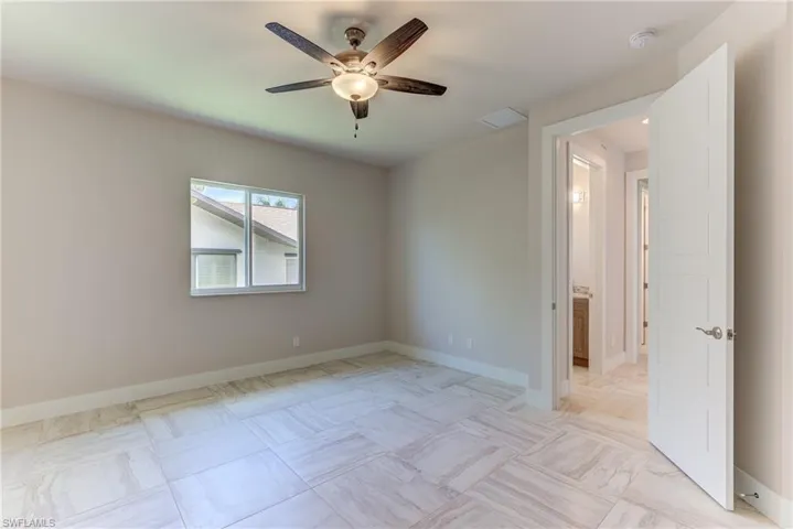 Empty room featuring baseboards and ceiling fan