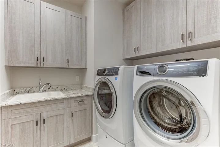 Laundry room featuring cabinet space and washer and dryer