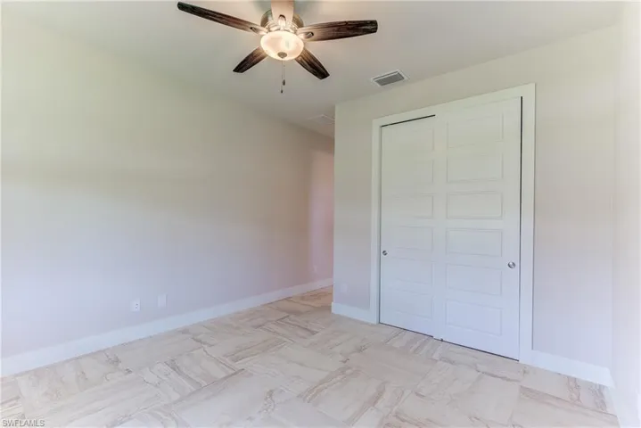 Unfurnished bedroom featuring a closet and ceiling fan