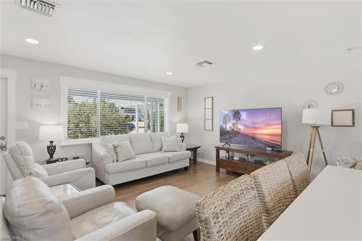 Living room with wood finished floors and recessed lighting