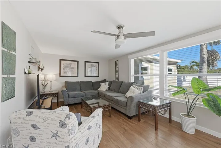Living area featuring wood finished floors and ceiling fan