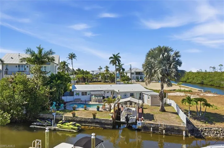 Dock area with a fenced backyard and a water view