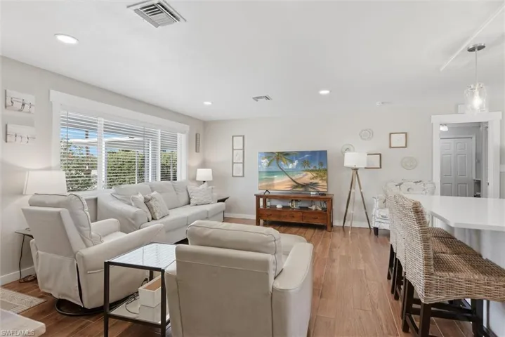 Living area featuring hardwood / wood-style floors and recessed lighting