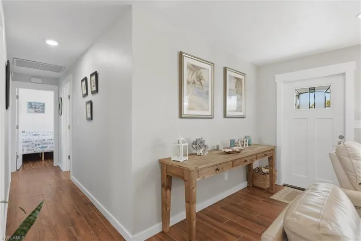 Foyer entrance with wood tiled floors and recessed lighting