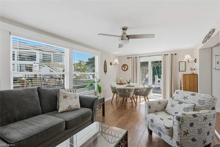 Living room featuring a ceiling fan and hardwood / wood-style flooring