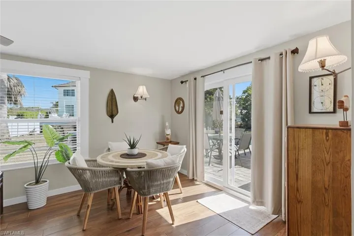 Dining space with hardwood / wood-style flooring and baseboards